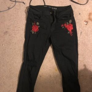 Black ripped American eagle jeans with roses